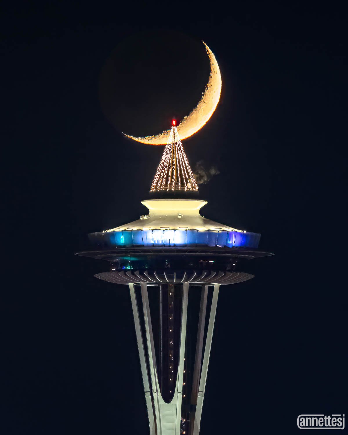 The Crescent Moon aligns with the Space Needle Christmas Tree.