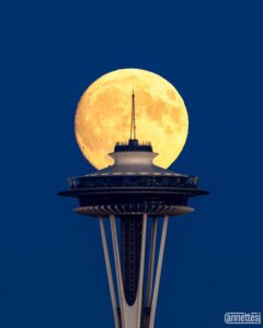 Full moon aligned with Space Needle, Seattle, Washington